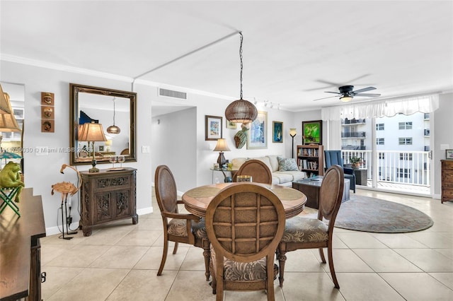 dining space featuring light tile patterned floors, ceiling fan, visible vents, baseboards, and crown molding