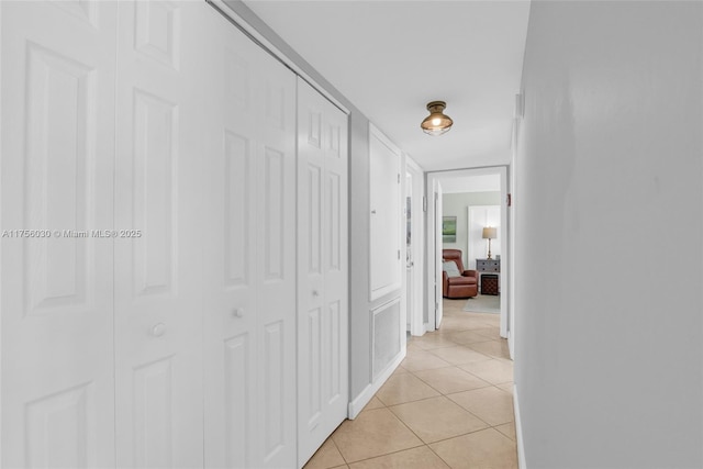 hall with visible vents and light tile patterned floors