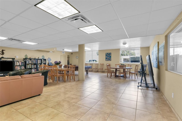 living area featuring a paneled ceiling, visible vents, and light tile patterned floors