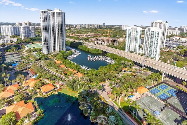 birds eye view of property with a city view and a water view