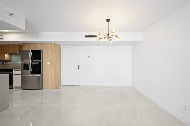 interior space with stainless steel fridge, electric range oven, modern cabinets, a chandelier, and brown cabinets