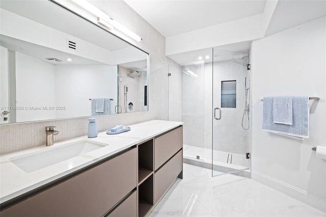 full bath featuring marble finish floor, vanity, a shower stall, and visible vents