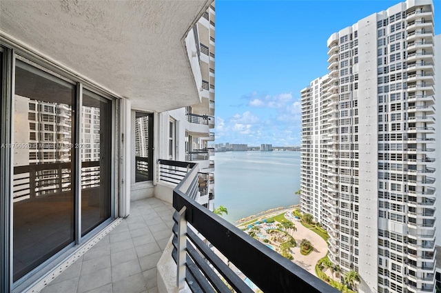 balcony featuring a view of city and a water view