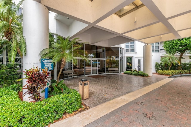 entrance to property featuring french doors and stucco siding