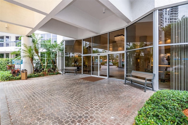 entrance to property featuring a patio area and stucco siding