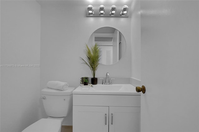 bathroom featuring toilet and vanity