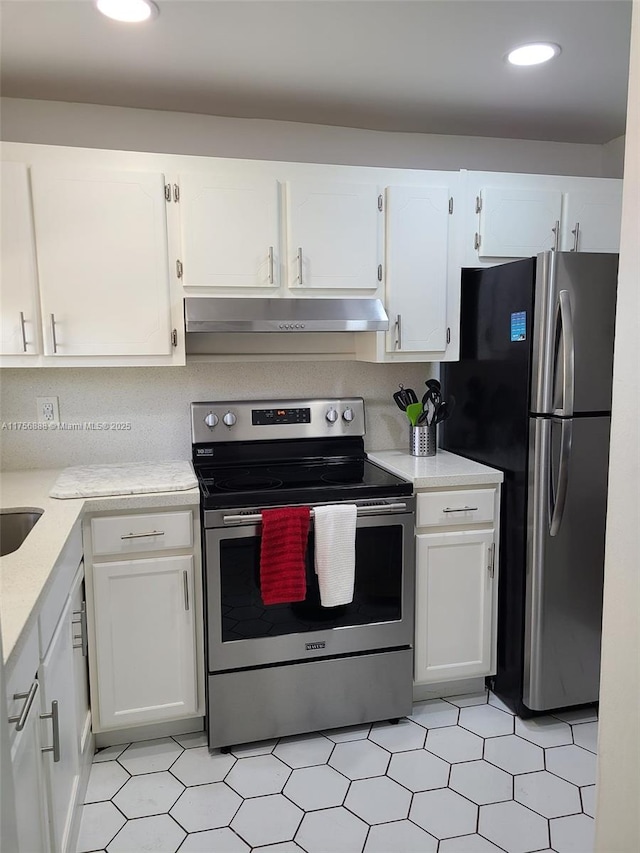 kitchen featuring white cabinets, under cabinet range hood, stainless steel appliances, and light countertops