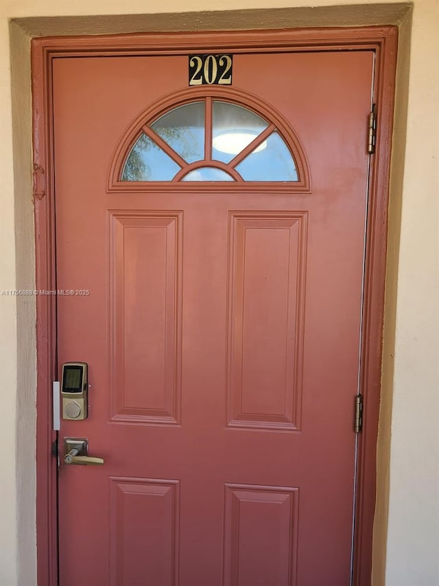 view of exterior entry featuring stucco siding