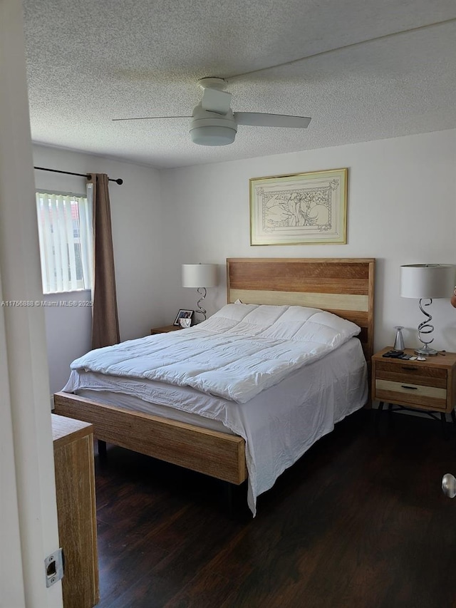 bedroom with ceiling fan, a textured ceiling, and wood finished floors