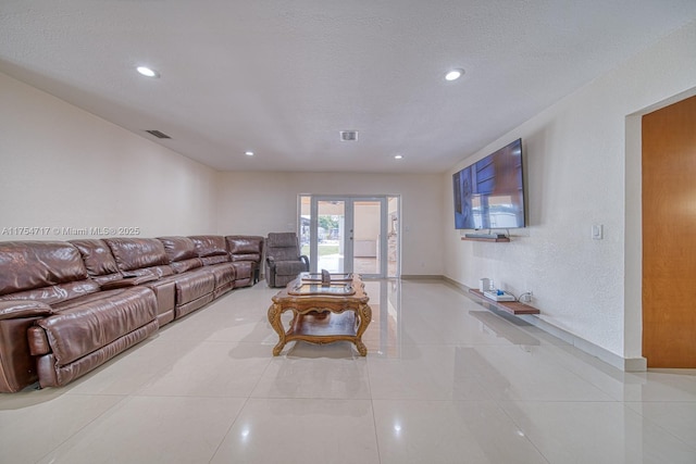 living area with recessed lighting, visible vents, a textured ceiling, french doors, and light tile patterned flooring