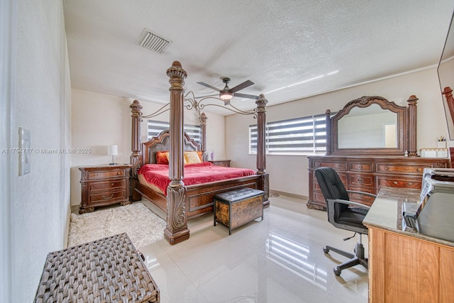 bedroom featuring visible vents, a textured ceiling, and light tile patterned flooring