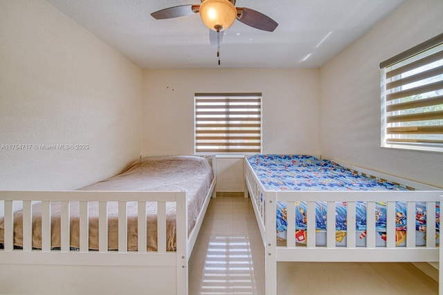 unfurnished bedroom featuring ceiling fan and a textured ceiling