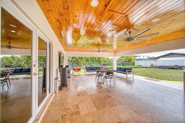 view of patio with fence, a ceiling fan, and an outdoor hangout area