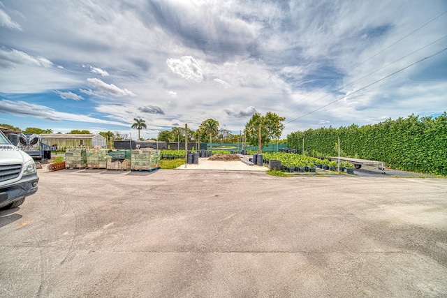 view of parking with fence