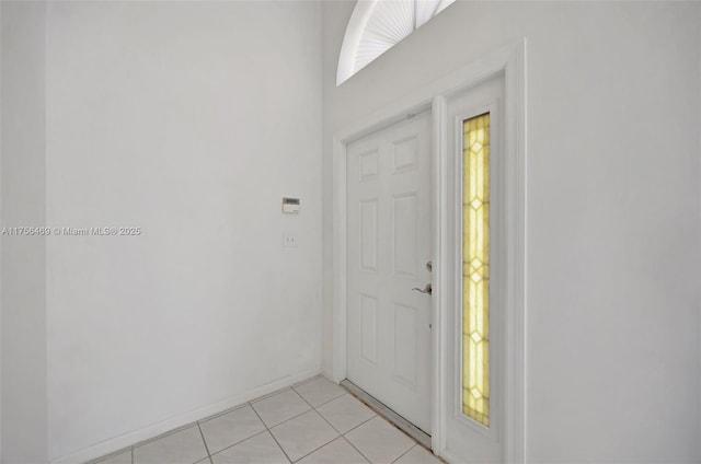 entryway featuring light tile patterned flooring and baseboards