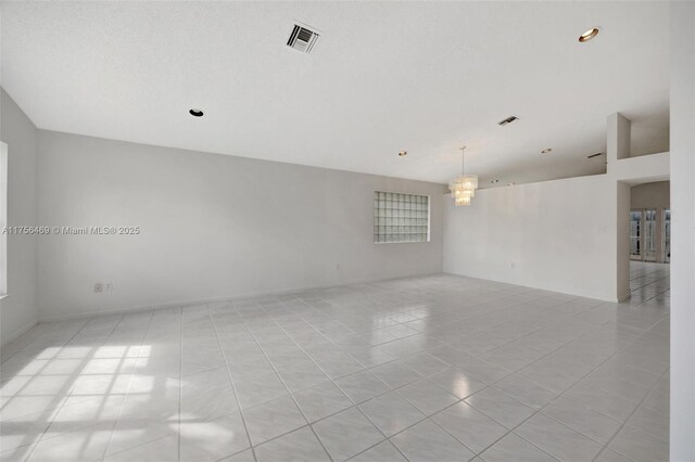 9820 SW 154th Pl, Miami, FL 33196 - spare room with visible vents, an inviting chandelier, and light tile patterned flooring