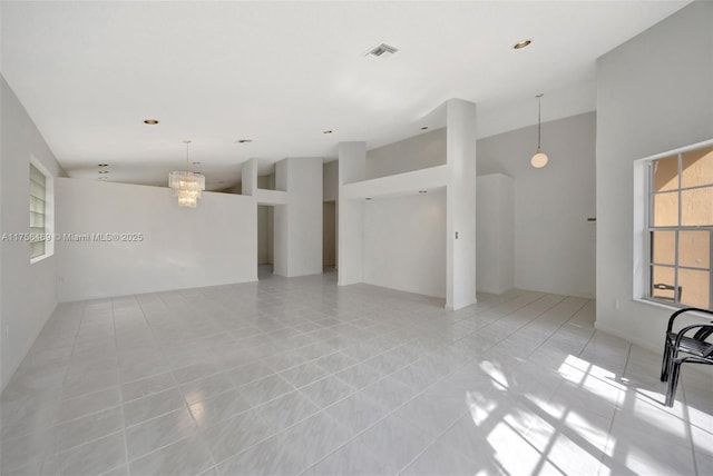 empty room with light tile patterned floors and visible vents