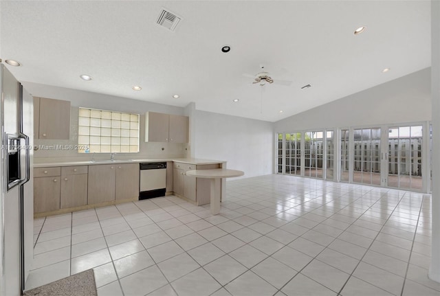 kitchen featuring visible vents, dishwashing machine, open floor plan, a peninsula, and light tile patterned flooring