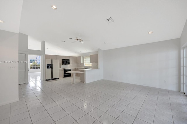 unfurnished living room featuring a wealth of natural light, visible vents, ceiling fan, and light tile patterned flooring