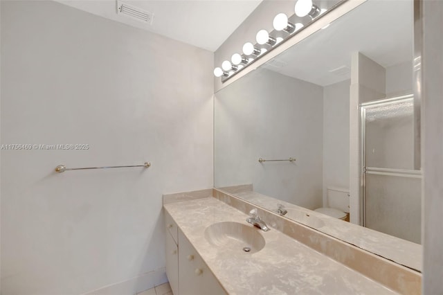 bathroom with a stall shower, visible vents, vanity, and toilet