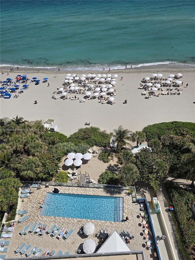 birds eye view of property featuring a water view and a beach view