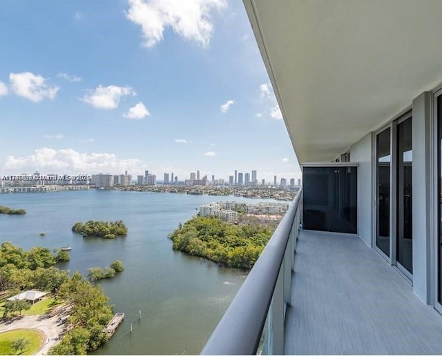 balcony with a view of city and a water view