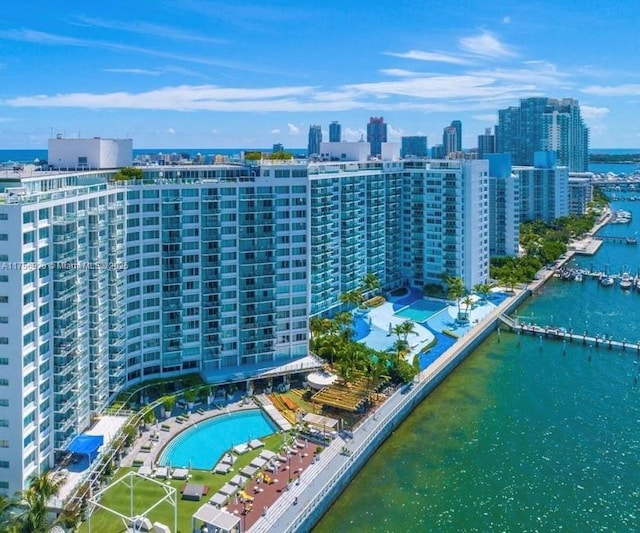 drone / aerial view featuring a water view and a city view