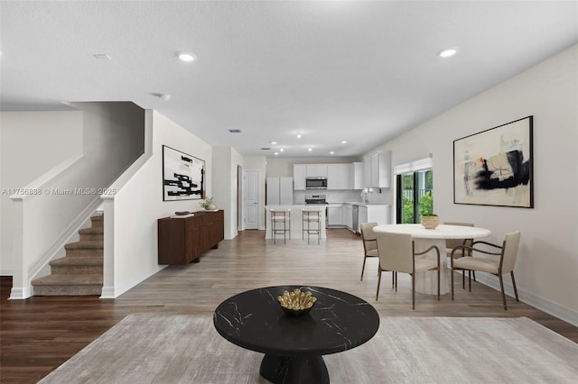 3142 Poinciana St, Lauderdale Lakes, FL 33311 - living area featuring stairway, baseboards, light wood-type flooring, and recessed lighting