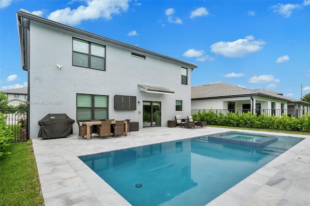 3142 Poinciana St, Lauderdale Lakes, FL 33311 - back of property with a pool with connected hot tub, fence, stucco siding, and a patio area
