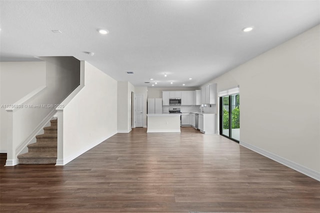 3142 Poinciana St, Lauderdale Lakes, FL 33311 - unfurnished living room featuring wood finished floors, baseboards, and recessed lighting
