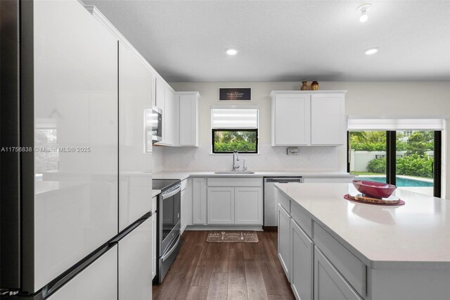 3142 Poinciana St, Lauderdale Lakes, FL 33311 - kitchen featuring light countertops, a wealth of natural light, stainless steel appliances, and a sink