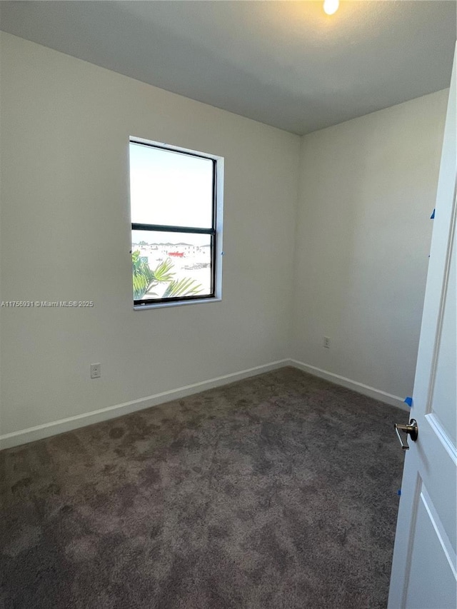 13384 SW 287th St, Homestead, FL 33033 - empty room with dark colored carpet and baseboards