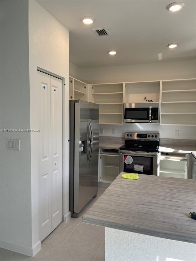 13384 SW 287th St, Homestead, FL 33033 - kitchen featuring open shelves, light tile patterned floors, visible vents, and stainless steel appliances