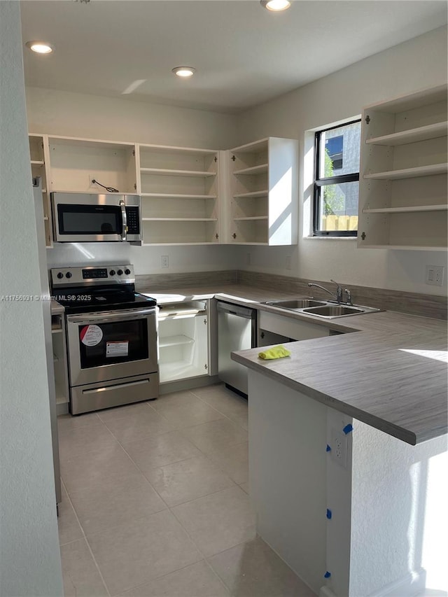 13384 SW 287th St, Homestead, FL 33033 - kitchen featuring light tile patterned floors, stainless steel appliances, open shelves, and a sink