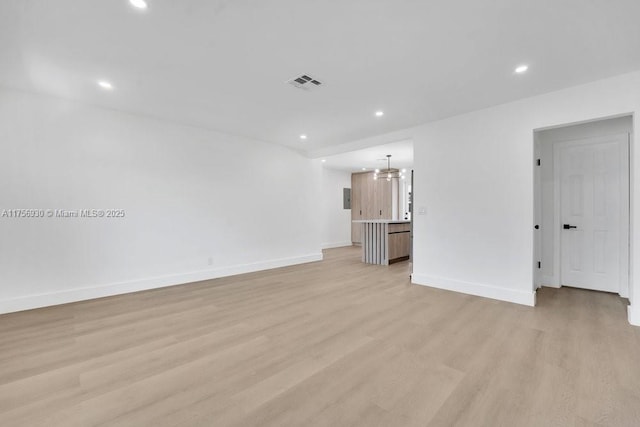 interior space featuring recessed lighting, baseboards, visible vents, and light wood finished floors