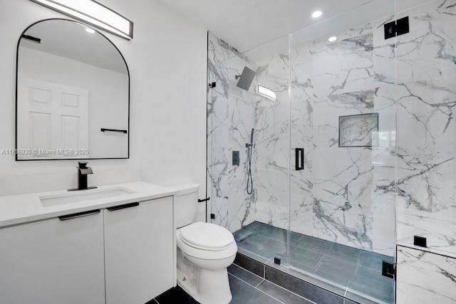 bathroom with a marble finish shower, vanity, toilet, and recessed lighting