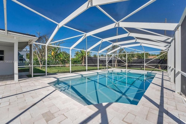 view of pool with a fenced in pool, glass enclosure, and a patio