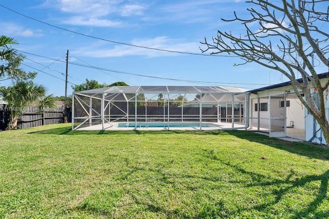 view of yard with glass enclosure, a fenced backyard, and a fenced in pool