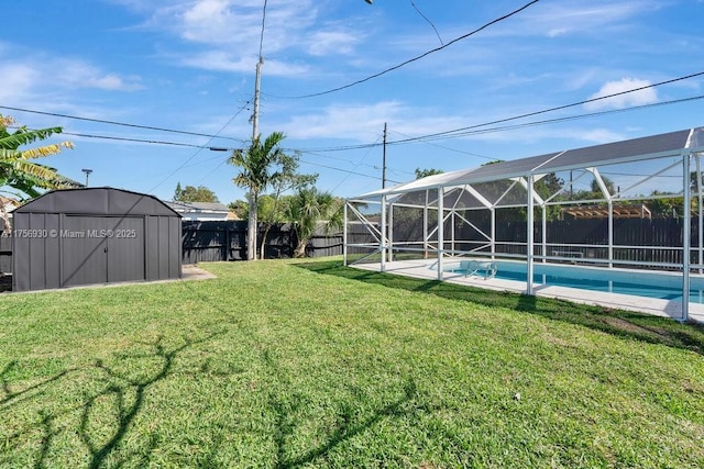 view of yard featuring a fenced in pool, glass enclosure, a shed, a fenced backyard, and an outdoor structure