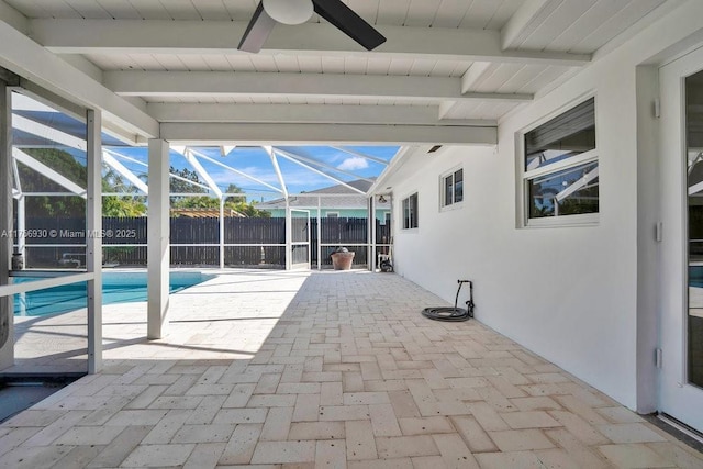 view of patio with a lanai, ceiling fan, and fence