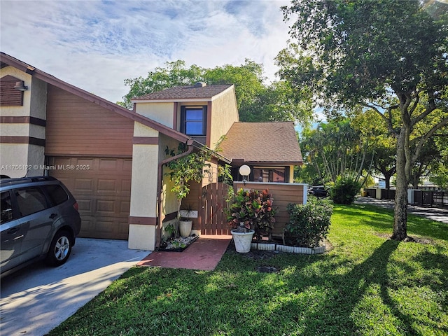 view of front facade featuring driveway, a shingled roof, stucco siding, an attached garage, and a front yard