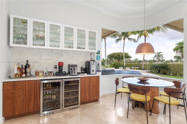 bar with a bar, wine cooler, ornamental molding, and backsplash