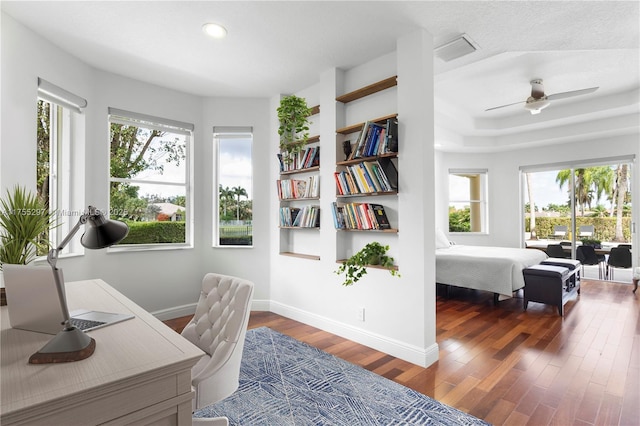 home office featuring ceiling fan, baseboards, and wood finished floors