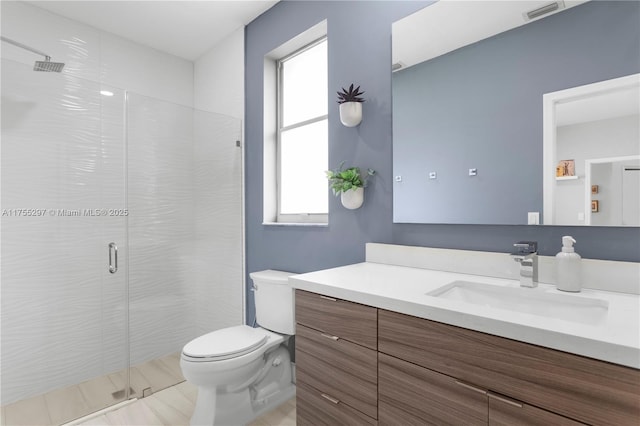 full bathroom featuring toilet, a shower stall, visible vents, and vanity