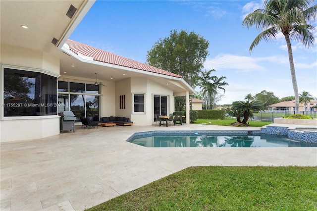 view of pool featuring a lawn, a patio, an outdoor hangout area, fence, and a pool with connected hot tub