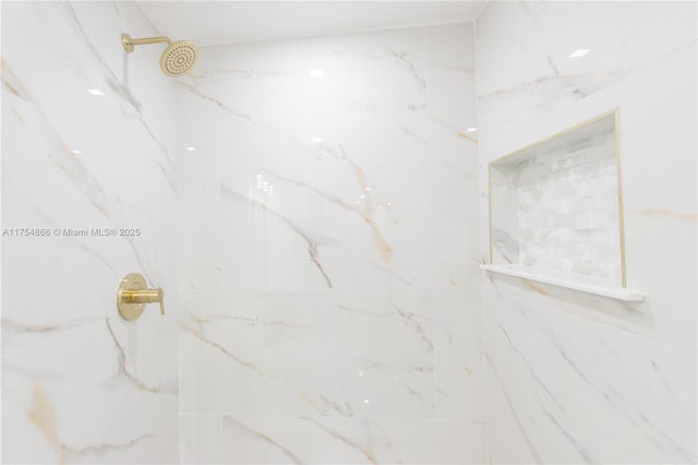 bathroom featuring a marble finish shower