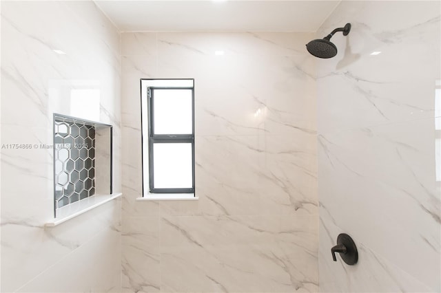 bathroom with a marble finish shower