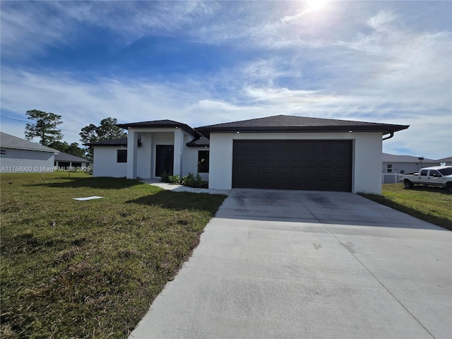 prairie-style house with a garage, driveway, a front lawn, and stucco siding