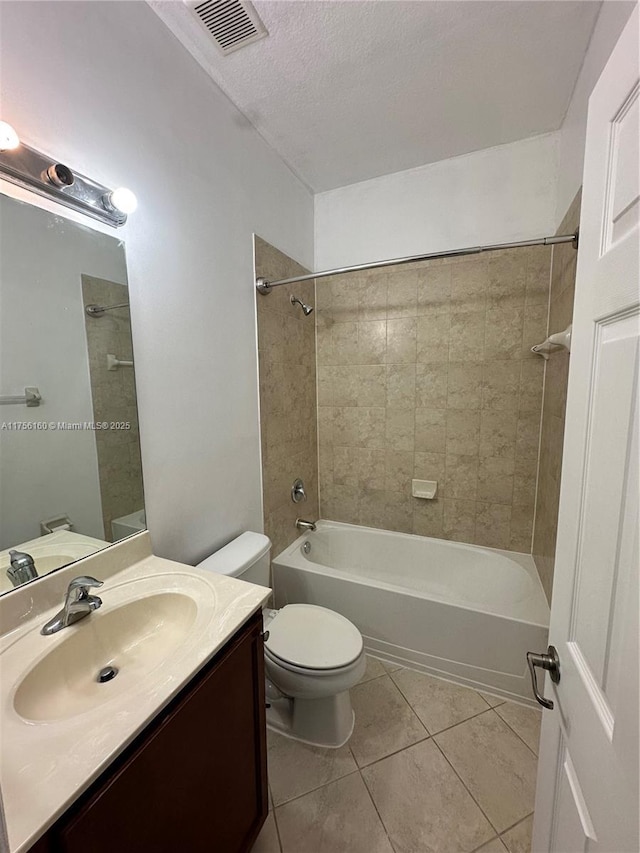 bathroom with tile patterned flooring, toilet, vanity, visible vents, and shower / bathing tub combination