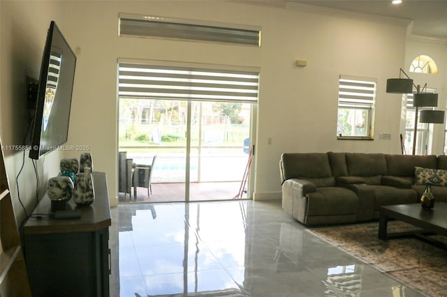 living area with baseboards, marble finish floor, recessed lighting, and crown molding